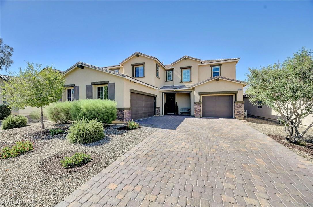 Image 1: Elegant two-story residence with a paved driveway