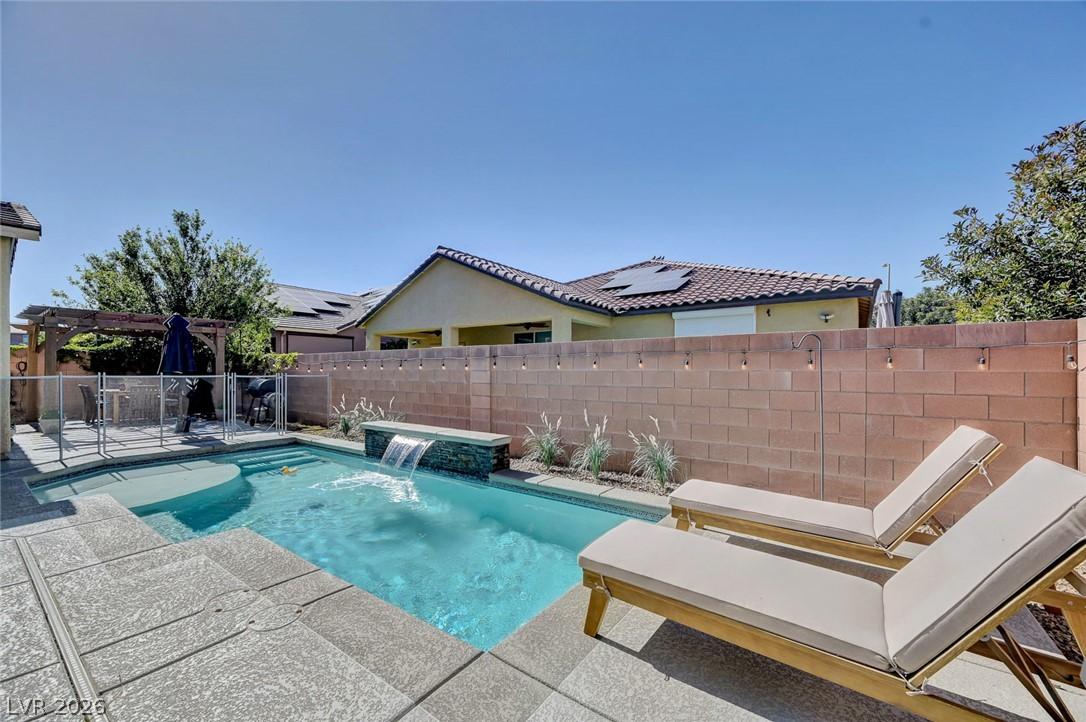 Image 2: An inviting backyard oasis features a shimmering p