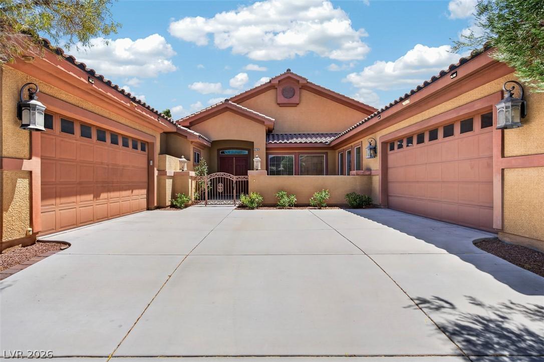 Image 1: Two spacious garages flank the entry of this invit