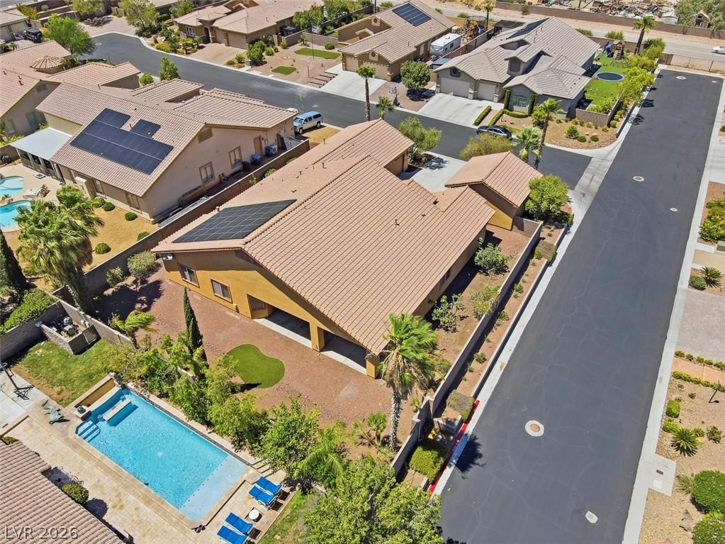 Image 2: An aerial perspective reveals a home with solar pa