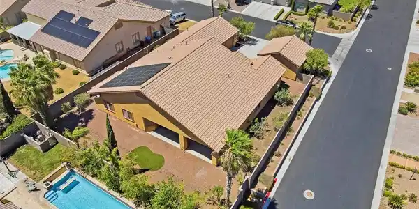 Image 2: An aerial perspective reveals a home with solar pa
