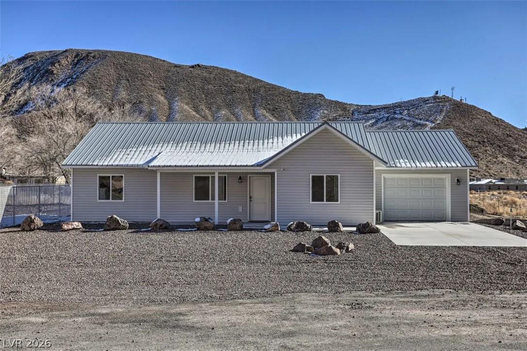 Image 1: A residence with a durable metal roof sits against