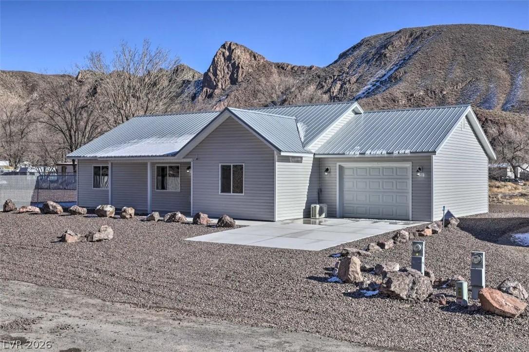 Image 2: A striking modern ranch-style home set against a r