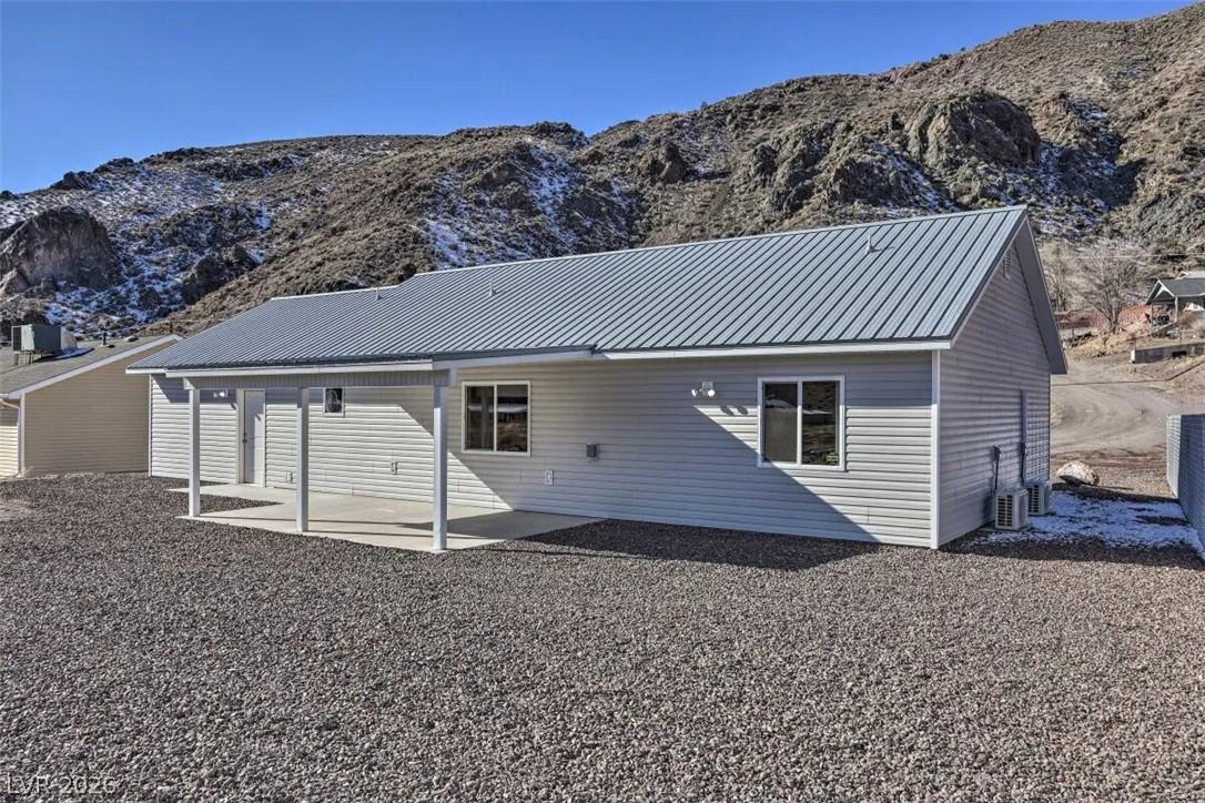Image 3: Home with a metal roof and a covered patio, nestle