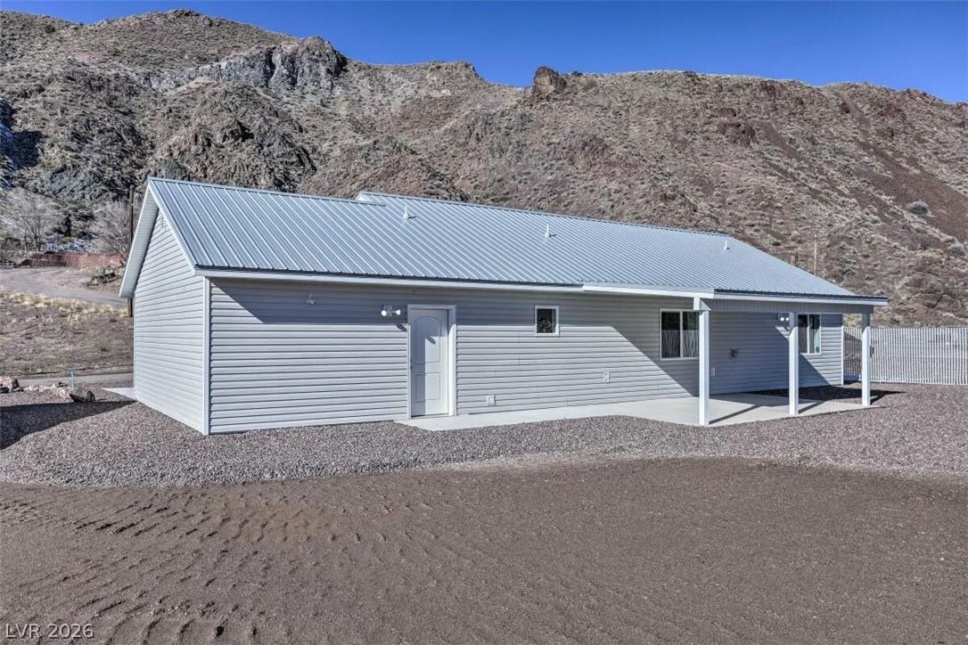 Image 4: A modern home nestled against a rugged mountain la