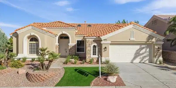 Image 2: A classic Spanish tile roof and stone accents defi