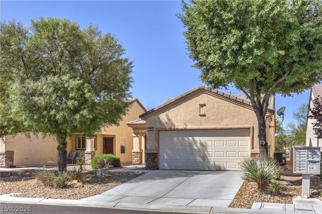 Image 2: This desert-landscaped home features a spacious dr
