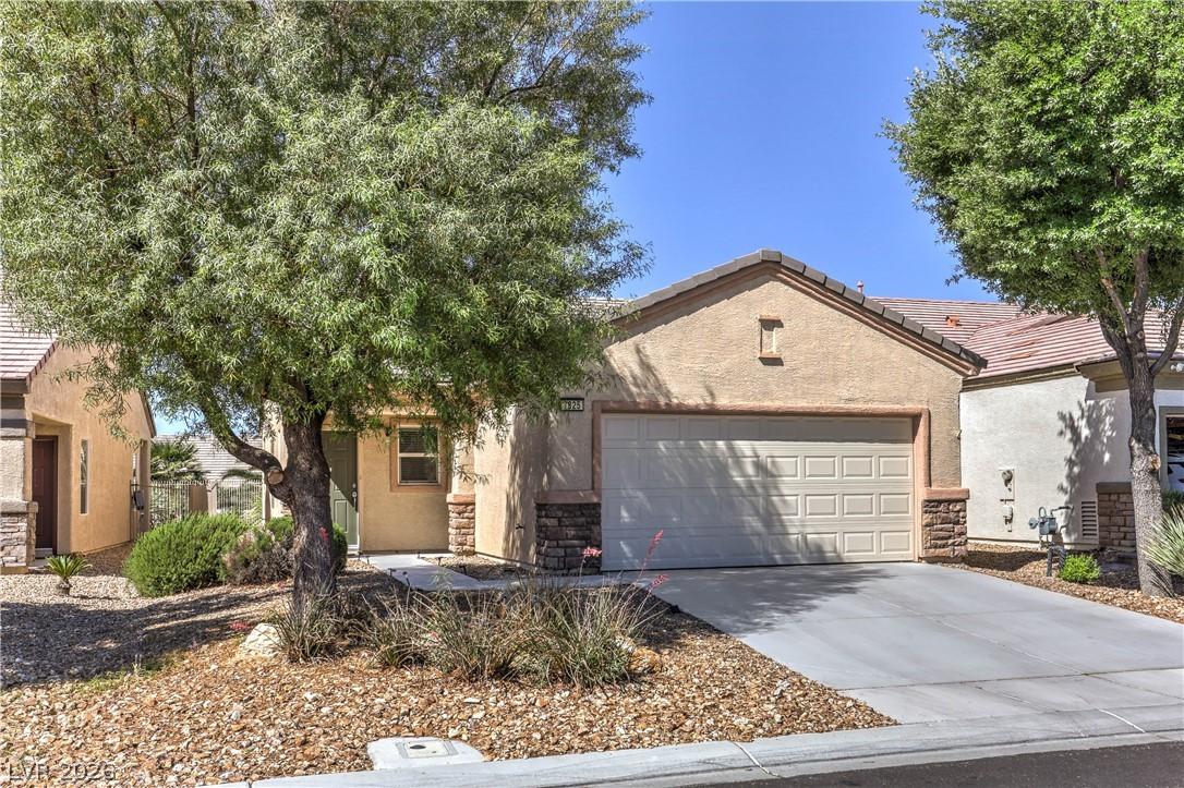 Image 3: This charming home offers a convenient garage and