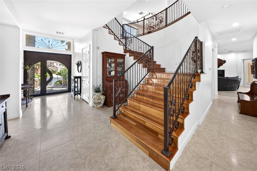 Image 4: Ornate wrought iron banisters guide the eye up a g
