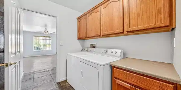 Image 4: Functional laundry space featuring durable tile fl
