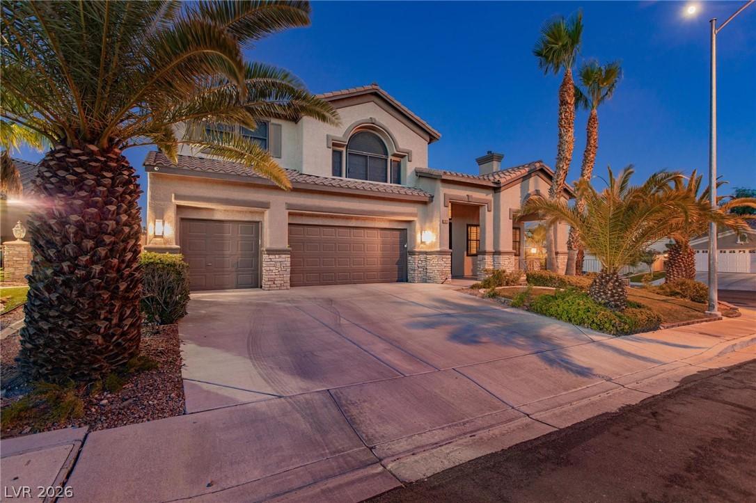 Image 4: A grand two-story residence with a paved driveway