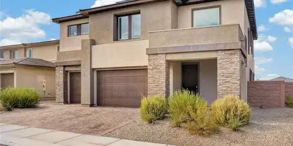 Image 2: A modern facade with stacked stone accents and an