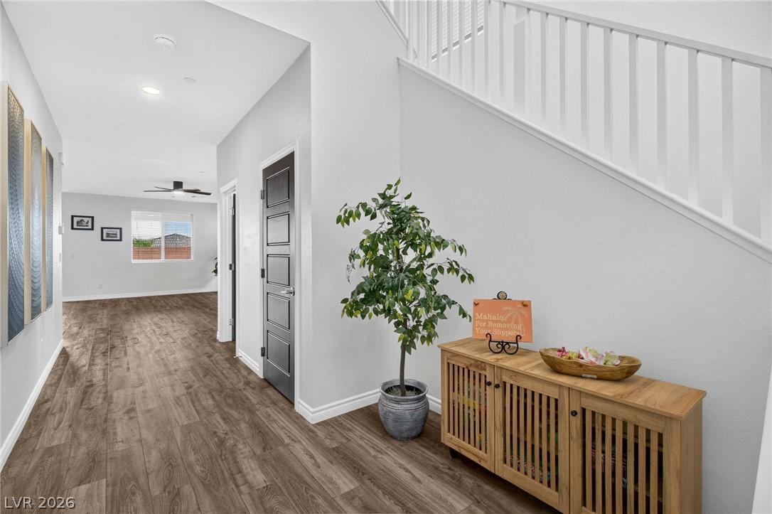 Image 4: An inviting entry hallway features warm wood floor