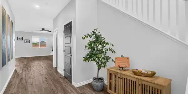Image 4: An inviting entry hallway features warm wood floor