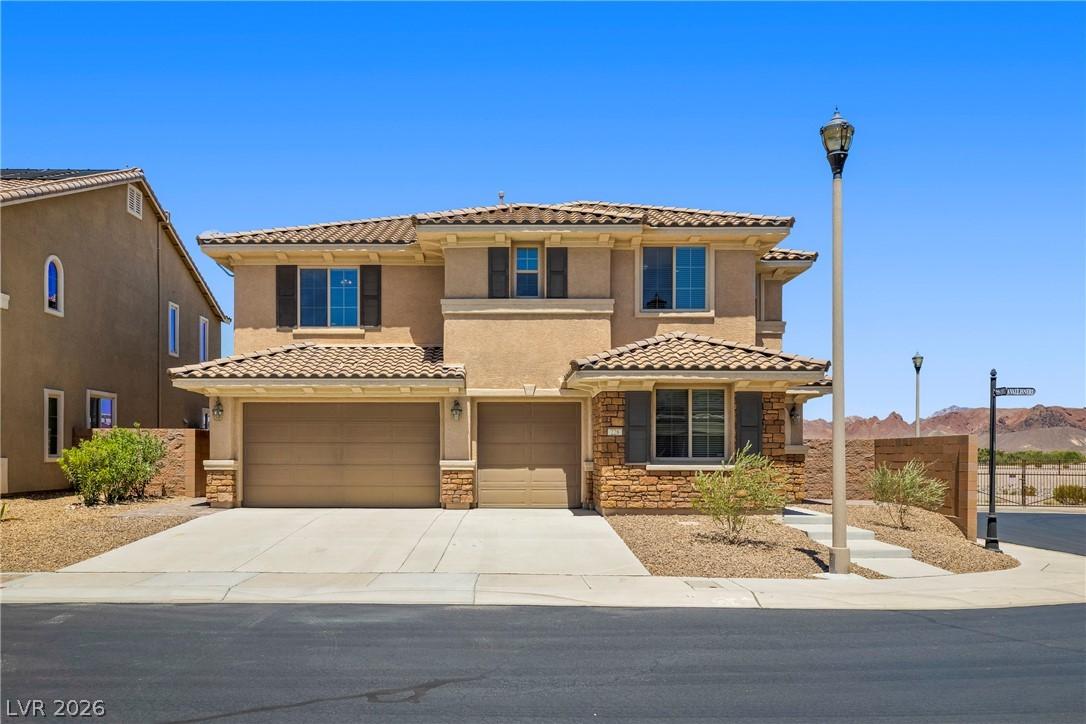 Image 1: A well-maintained stucco home with stone accents a