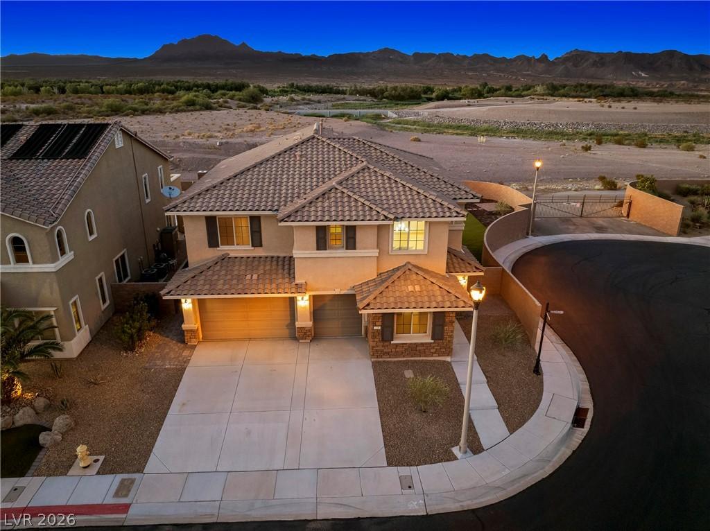 Image 2: A classic two-story residence with a tiled roof an