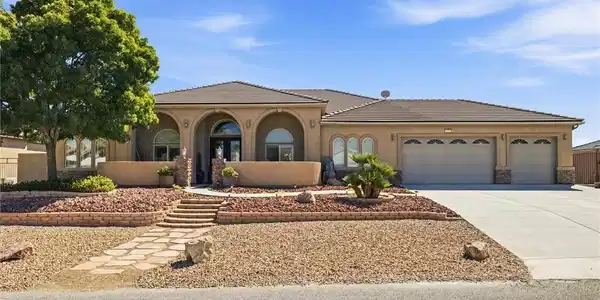 Image 2: A terracotta-tiled roof crowns this stucco home, f