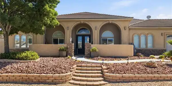 Image 4: Arched entryways and a terraced stone walkway welc