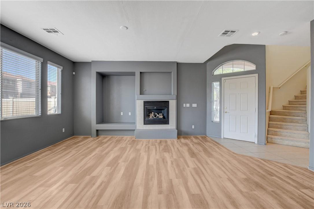 Image 3: A welcoming entryway with a central fireplace prov