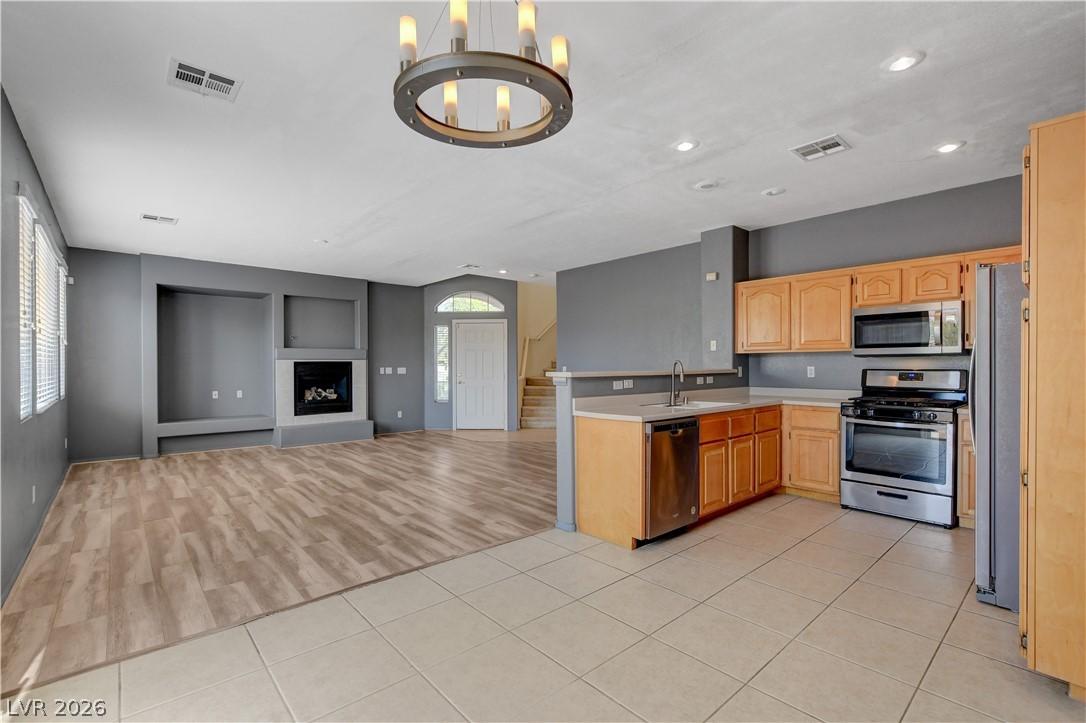 Image 4: An open concept living area transitions from tiled