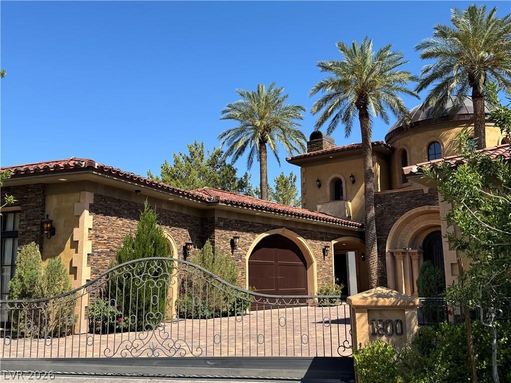 Image 3: An expansive wrought iron gates introduce a privat