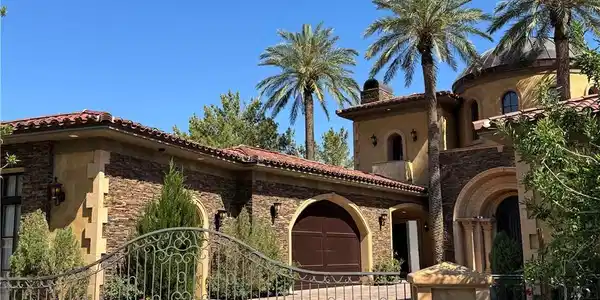 Image 3: An expansive wrought iron gates introduce a privat