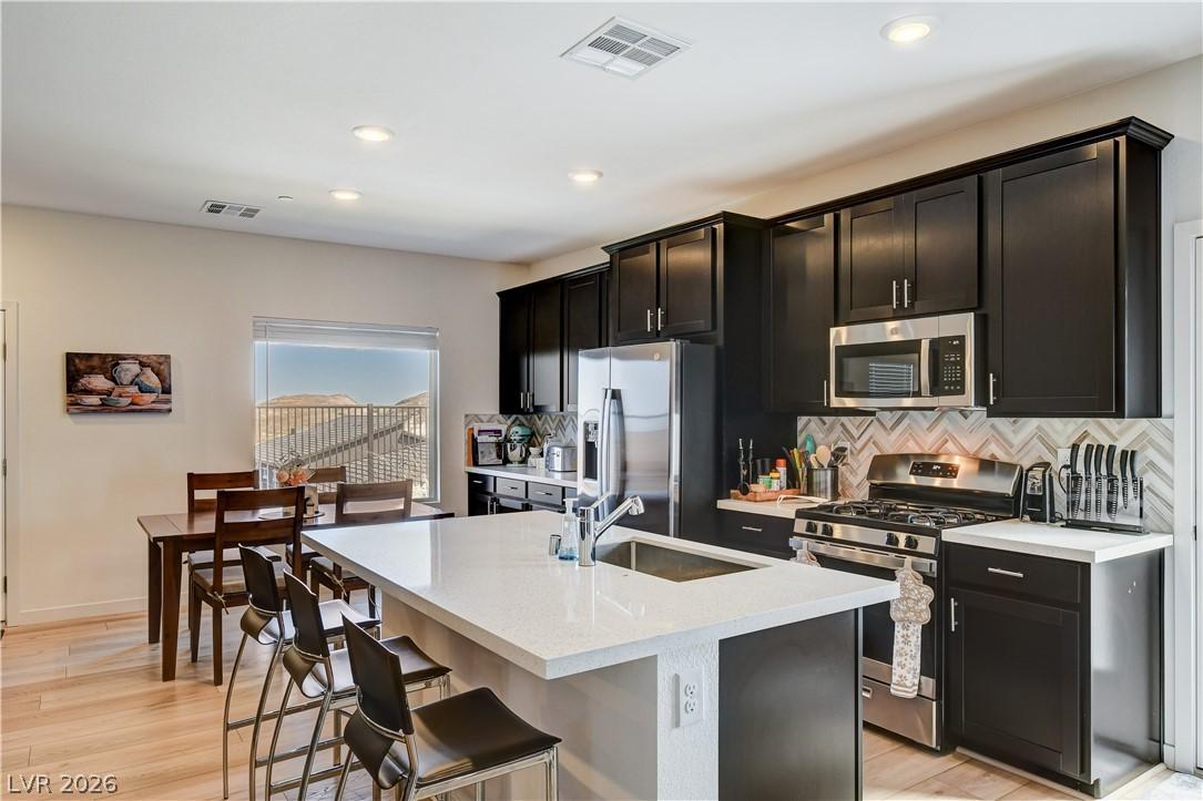 Image 3: This modern kitchen features a spacious island and