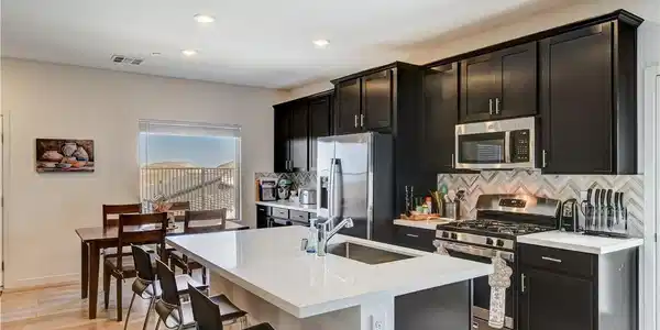 Image 3: This modern kitchen features a spacious island and