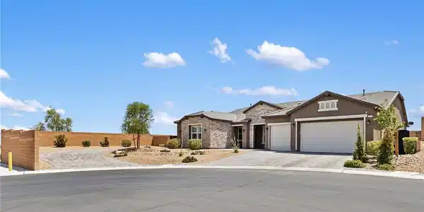 Image 2: A well-maintained cul-de-sac home features a stone