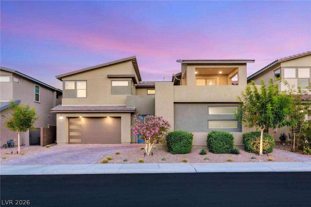 Image 1: Modern desert architecture with a welcoming garage