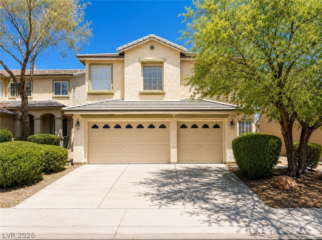 Image 2: Two-story desert home with a double garage and mat