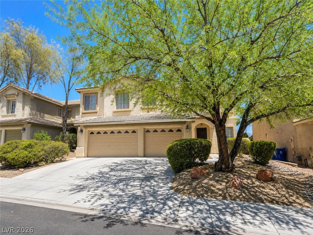 Image 3: A classic facade with a spacious driveway and matu