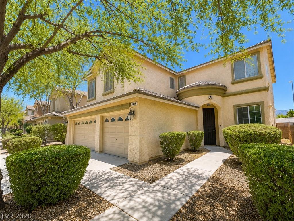 Image 4: A classic two-story stucco residence, offering a w