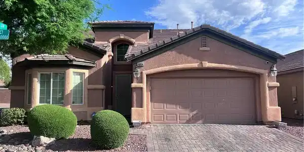 Image 2: A classic stucco exterior frames the front of this