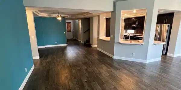 Image 3: Rich wood-look flooring contrasts beautifully with
