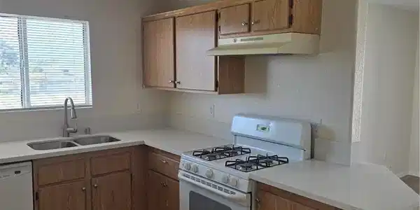 Image 3: Kitchen featuring refrigerator, wood finish cabine