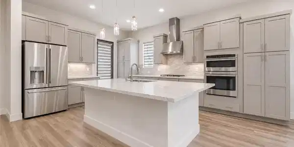 Image 4: A chef's dream kitchen features an oversized islan