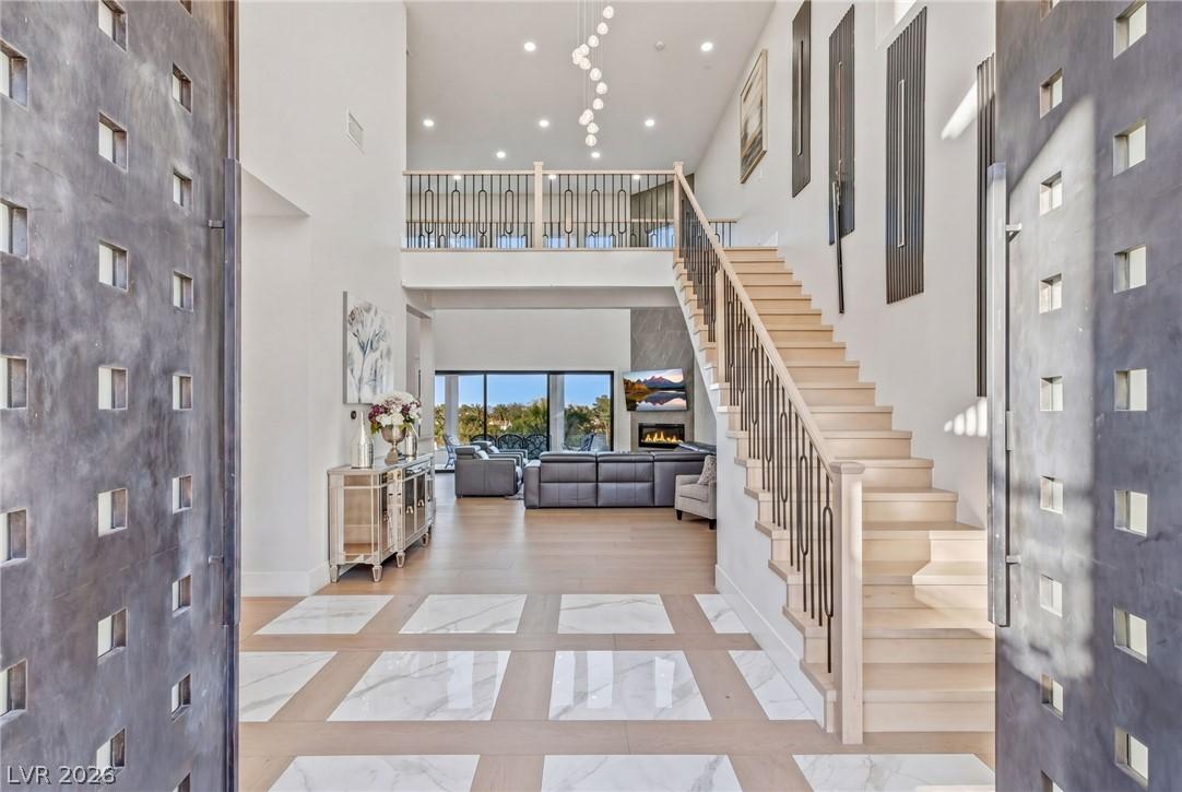 Image 2: This spacious foyer presents a grand entrance with
