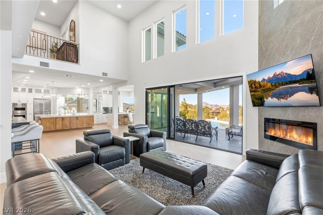 Image 3: This grand living space features high ceilings, an