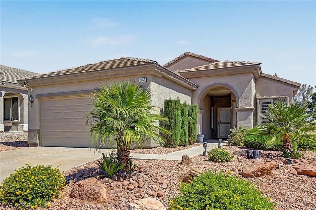 Image 1: A well-maintained stucco home offers a welcoming a