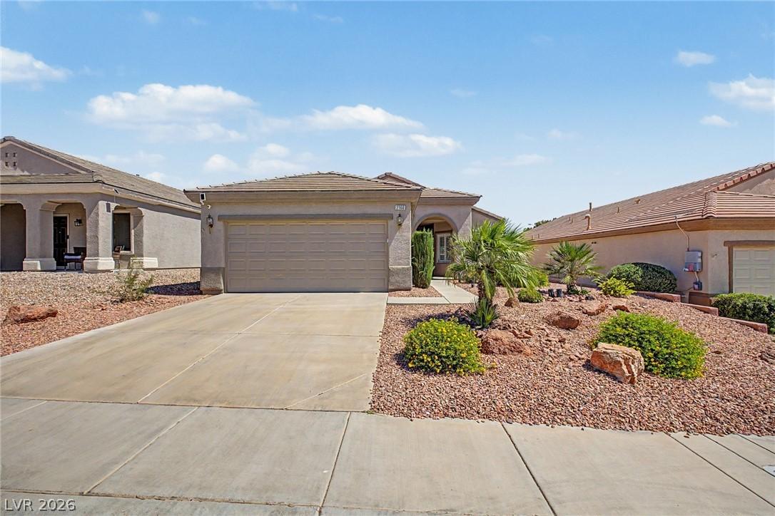 Image 4: A desert oasis with a paved driveway and low-maint