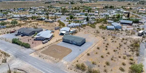 Image 3: An aerial perspective reveals a vast desert commun
