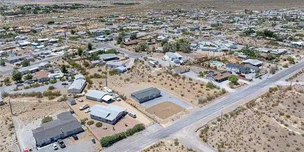 Image 4: An aerial perspective reveals a sprawling desert c