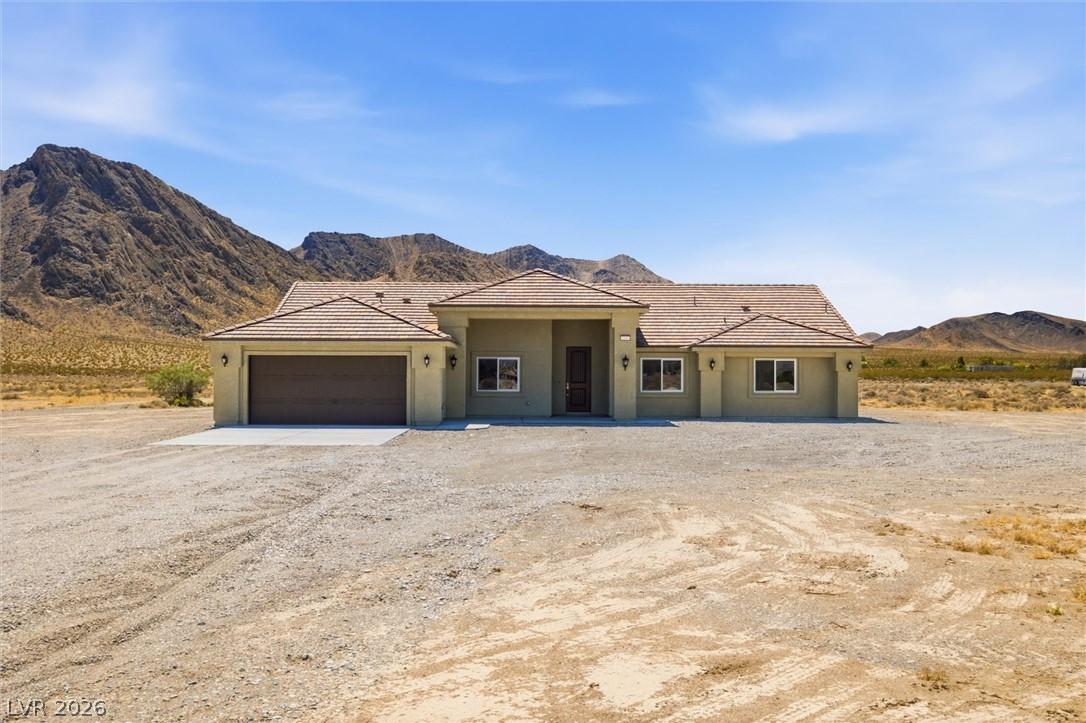Image 2: A desert oasis home, set against a dramatic mounta