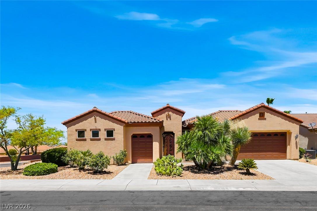 Image 1: A charming stucco home with a terracotta tile roof