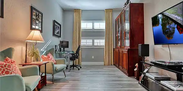 Image 4: A versatile space features durable plank flooring,