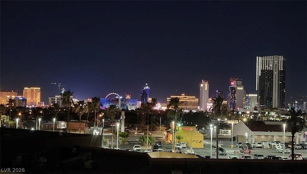 Image 1: Vibrant city lights illuminate the night sky, show