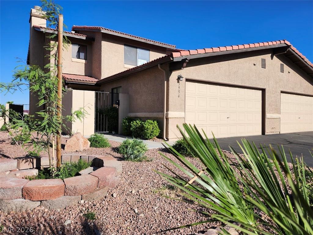 Image 2: A well-maintained stucco home with a tile roof and