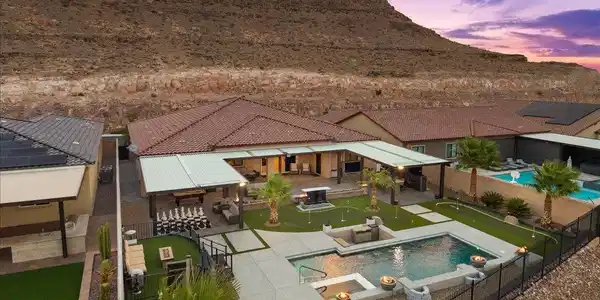 Image 3: Dramatic mountain vistas rise behind a resort-styl