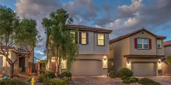 Image 3: A modern multi-level residence features stucco sid